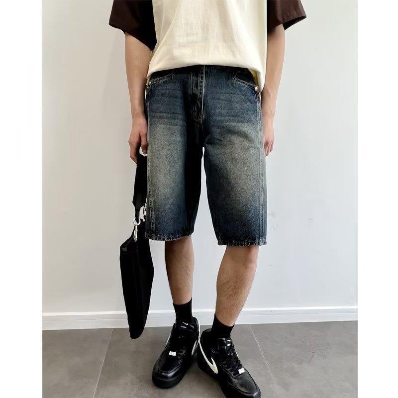 Model wearing washed loose straight denim shorts in a relaxed skater style from Novien Apparel