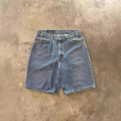 Distressed Y2K denim jeans in a loose fit style, showcasing vintage fashion and modern streetwear aesthetics.