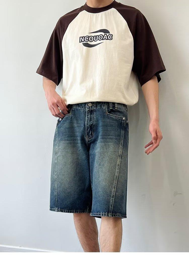 Model wearing washed loose straight denim shorts in a relaxed skater style from Novien Apparel