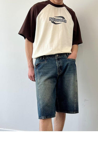 Model wearing washed loose straight denim shorts in a relaxed skater style from Novien Apparel