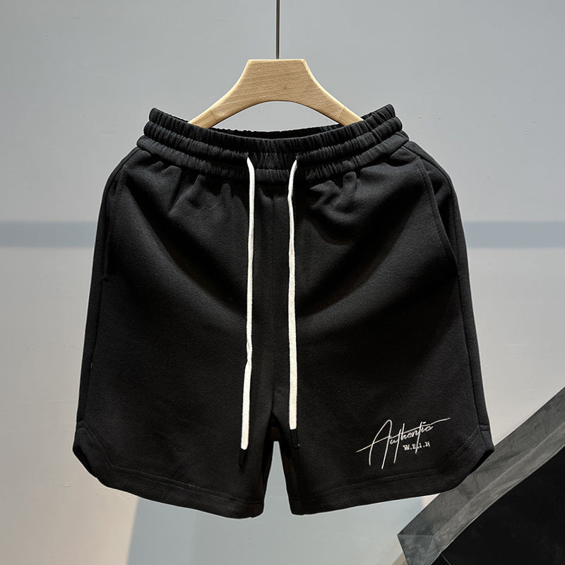 Man wearing black fitness loose casual drawstring shorts during a gym workout