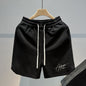 Man wearing black fitness loose casual drawstring shorts during a gym workout