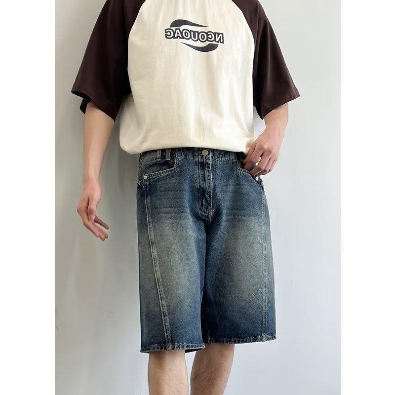 Model wearing washed loose straight denim shorts in a relaxed skater style from Novien Apparel