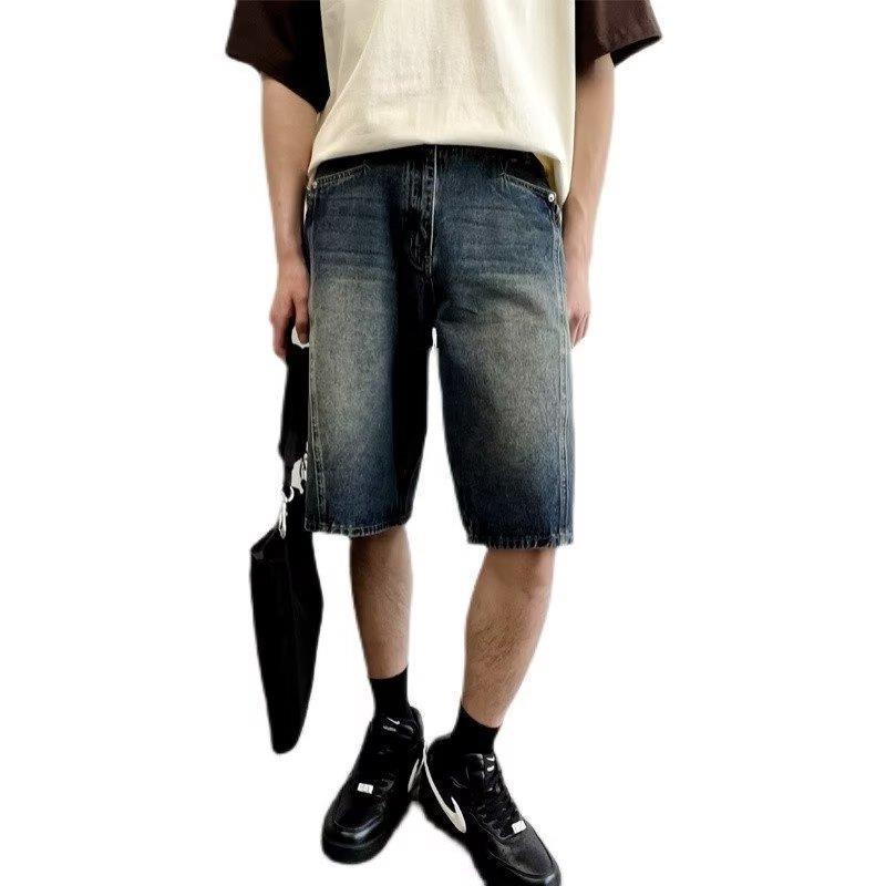 Model wearing washed loose straight denim shorts in a relaxed skater style from Novien Apparel