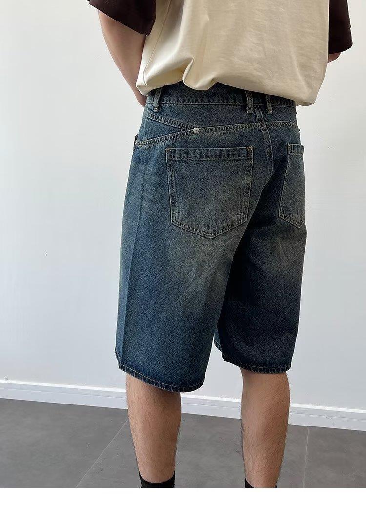 Model wearing washed loose straight denim shorts in a relaxed skater style from Novien Apparel